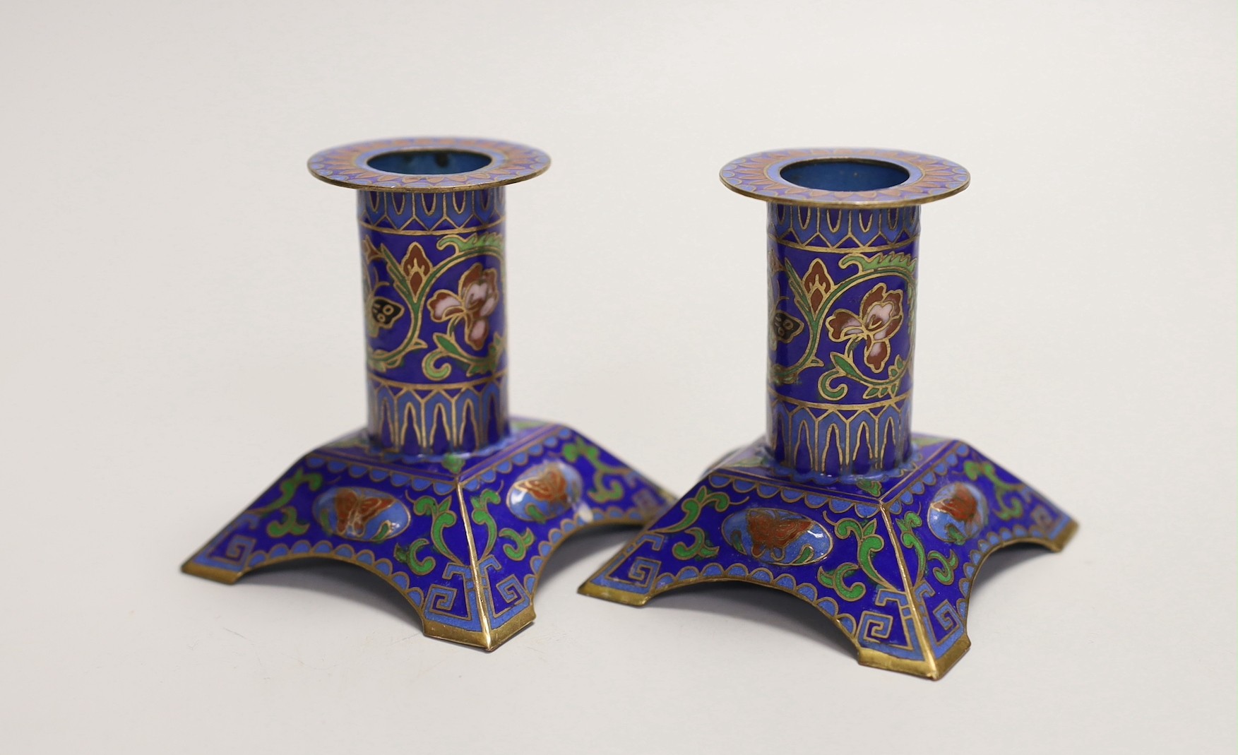 A pair of Chinese hardstone jardinières and a pair of champleve enamel candlesticks, tallest 16cm